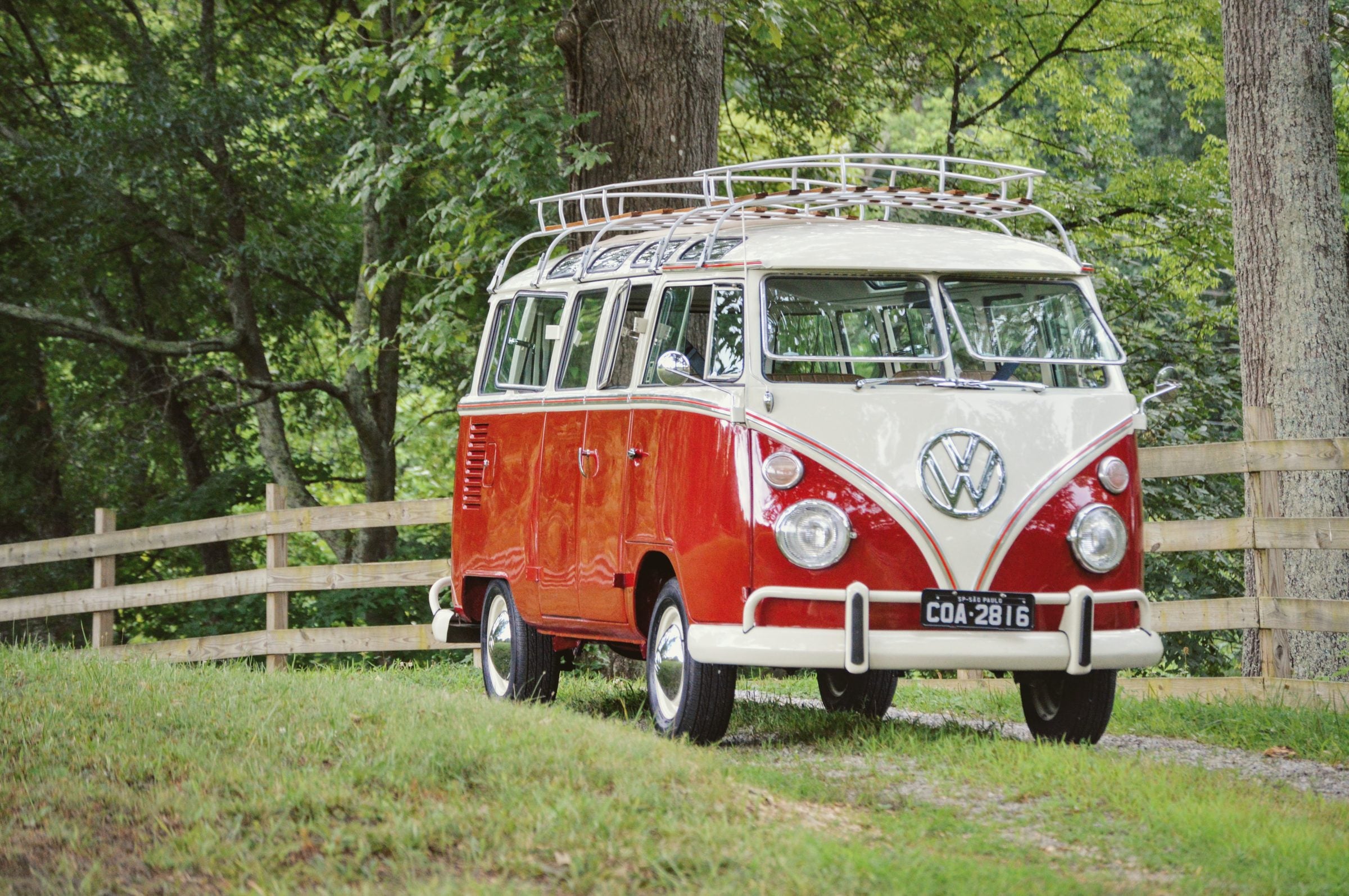 Restored red and white 23-window Volkswagen Bus by Overland Imports