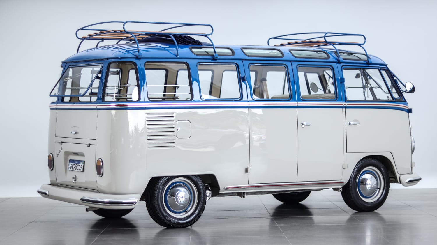 Restored blue and white 23-window Volkswagen Bus in the studio