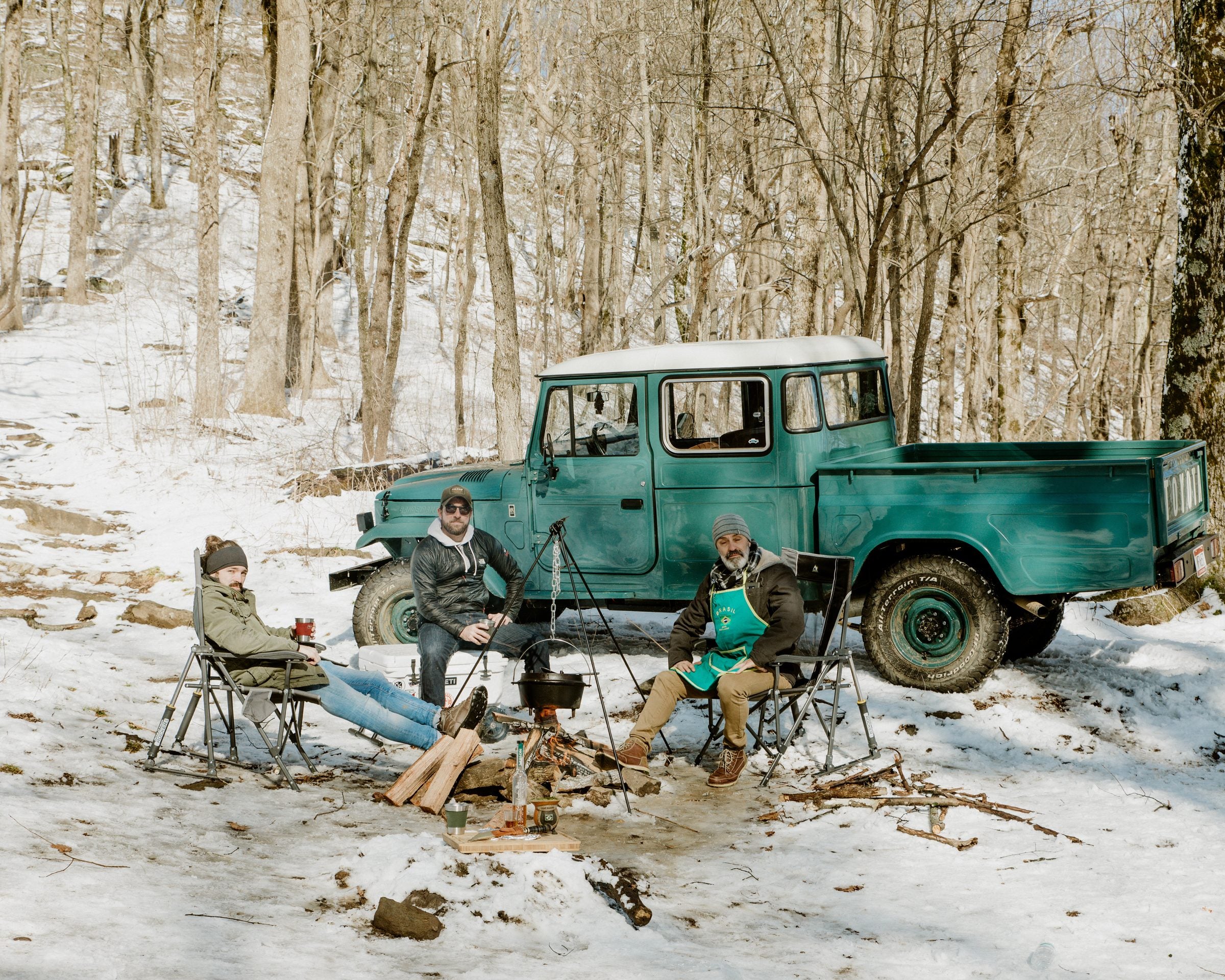 Teal Toyota Bandeirante pickup at a winter campfire with the Overland Imports team